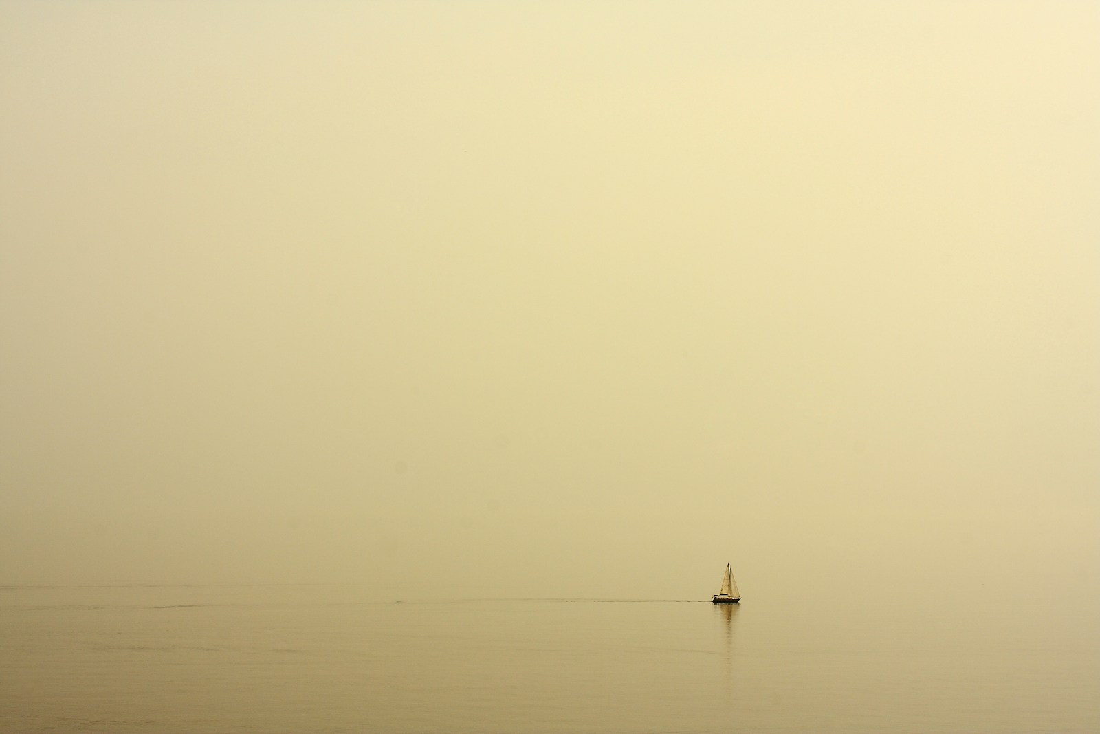 black sailboat on sea during daytime